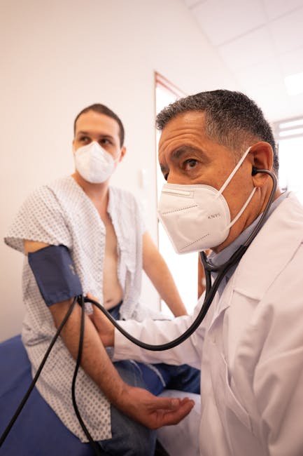 Healthcare professional measuring a patient's blood pressure during a clinical consultation.